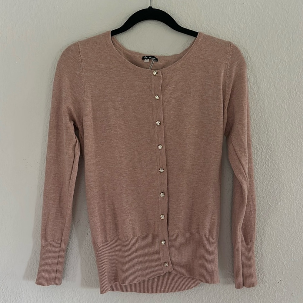 Blush colored cardigan with jeweled buttons.